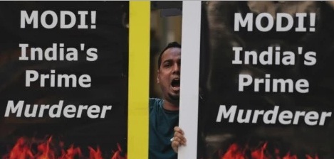 A protester with the Alliance for Justice and Accountability shouts slogans during a demonstration against Modi outside Madison Square Garden
