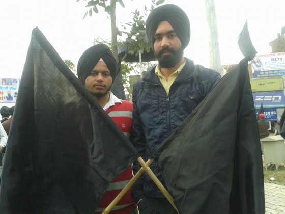 Sikh youth activists demonstrate with black flags on India's republic day
